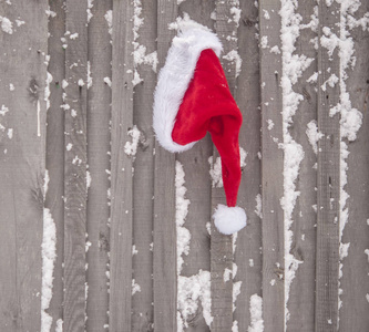 s cap on old wooden fence. Christmas and New Year concept.