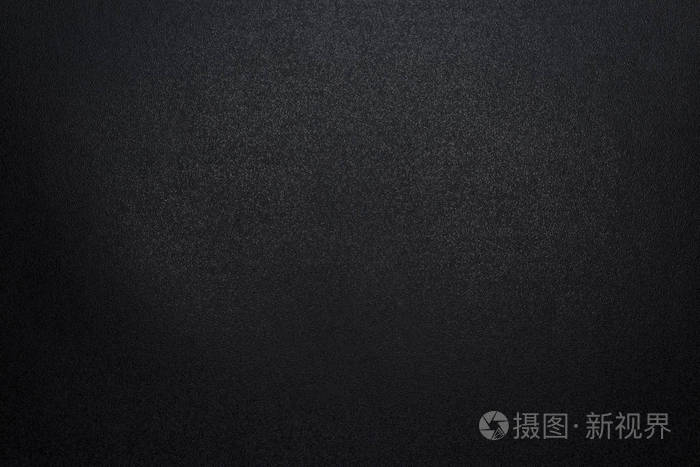 黑色,粗糙的纹理背景用昏暗的光线照亮.