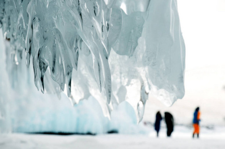 冷冻贝加尔水。 透明冰柱。 冰溅在冰封的岩石上，冰封时形成的石头
