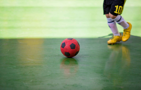 儿童丰满球员陷阱和控制球射击到目标。 足球运动员互相踢球。 室内足球运动场。 足球运动员足球