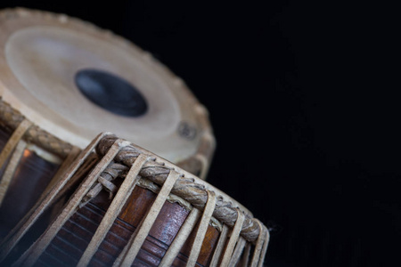 s hands wearing beads playing the Tabla  Indian classical mus