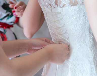 s hands lace up white wedding dress.