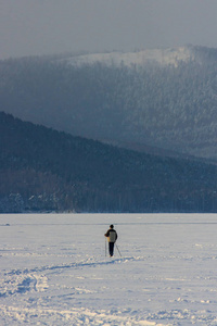 冬天滑雪者骑在山湖上。 囊性白雪和野生动物。 户外运动。 爱好和运动。