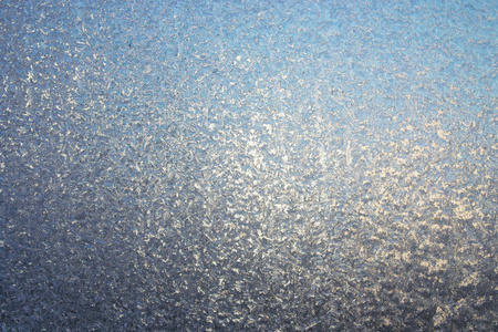 磨砂玻璃的质地。 冬季模式。 抽象纹理背景。