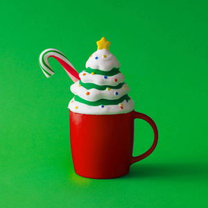 一杯带有圣诞树装饰和糖果的咖啡。 最小的食物概念。