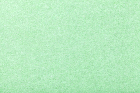浅绿色哑光背景的绒面织物特写. 天鹅绒质地无缝薄荷毛毡.照片