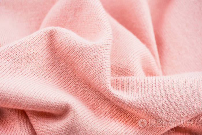 纹理针织毛衣特写在背景屏幕保护程序部分模糊的背景浅粉色