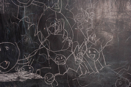 s drawings in chalk on a black chalk board. People in the childr