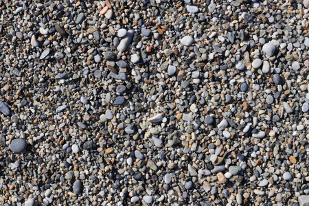 海滩石头表面。 海洋矿物美和谐。 海卵石质地。