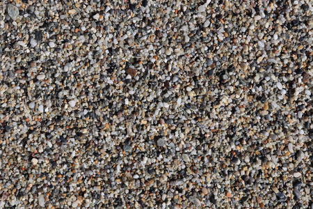 海洋小卵石纹理。 海滩石头表面。 海洋矿物美和谐。