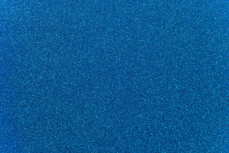 天空蓝色的砂纸纹理背景与火花和闪光照片