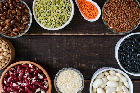  brown and white rice in bowls on a wooden table. Top view, flat