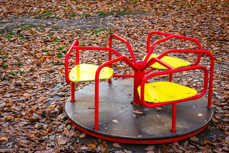 s playground. Yellow autumn leaves lying on the ground.