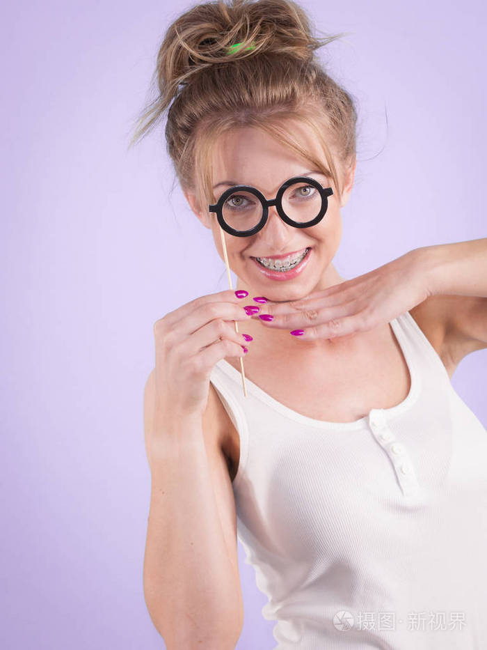 优雅的年轻女人假装戴着滑稽的书呆子眼镜. 教育和学习女性的观念.