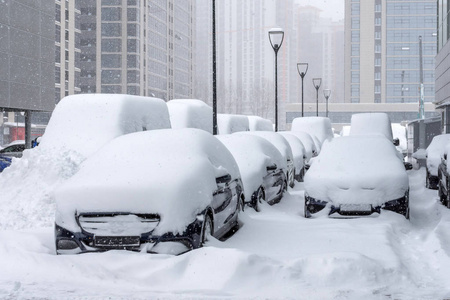 在暴风雪中，许多汽车停在城市的商业区。