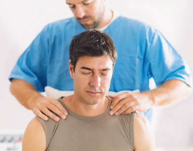 s shoulders and neck, Therapist wearing blue uniform, Osteopath