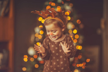 s Christmas party, cute little baby in rudolph costume clapping 