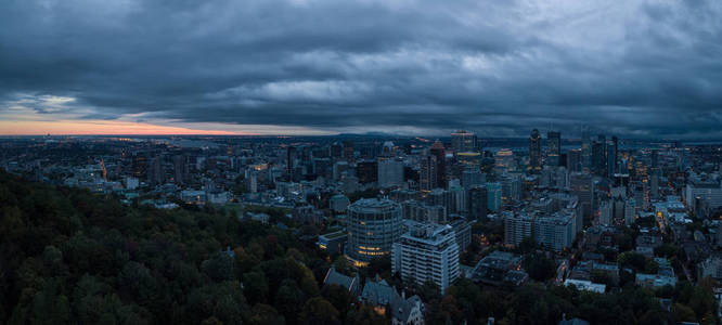 在一个引人注目的多云日出期间，一个美丽的现代市中心城市的空中全景。 摄于加拿大蒙特利尔魁北克。