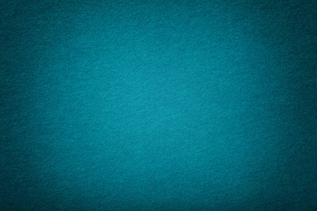 蓝羊深色绿松石哑光背景的绒面织物特写.