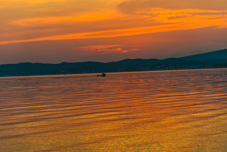 雄伟的橙色红色的日落天空和渔船