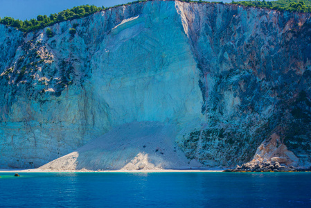 大悬崖的脚，周围有清澈的蓝海。