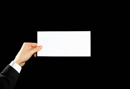 孤立在黑色背景上. 男人展示胶印纸. 单张模板. 手里拿着书.