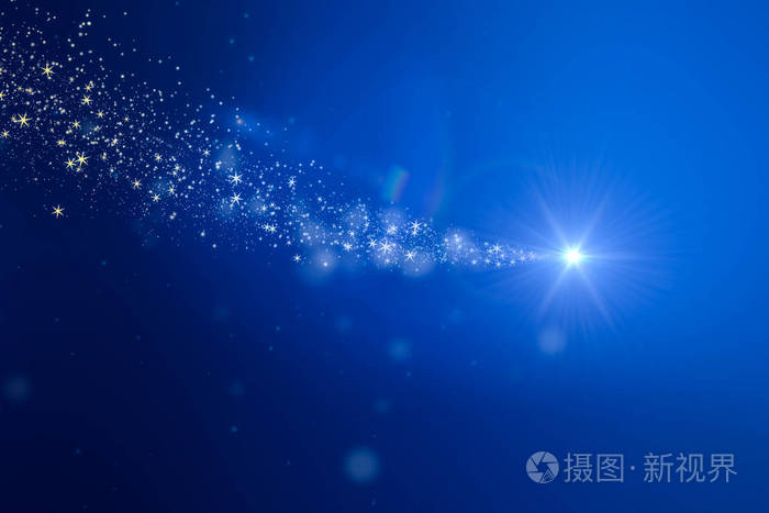 圣诞灯光闪耀粒子在蓝色背景下的节日概念