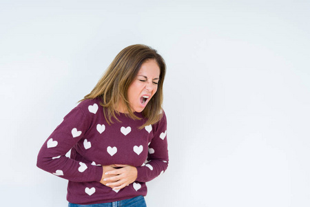 穿着心衫,在孤立的背景上,手放在肚子上,因为恶心,疼痛的疾病感觉不适