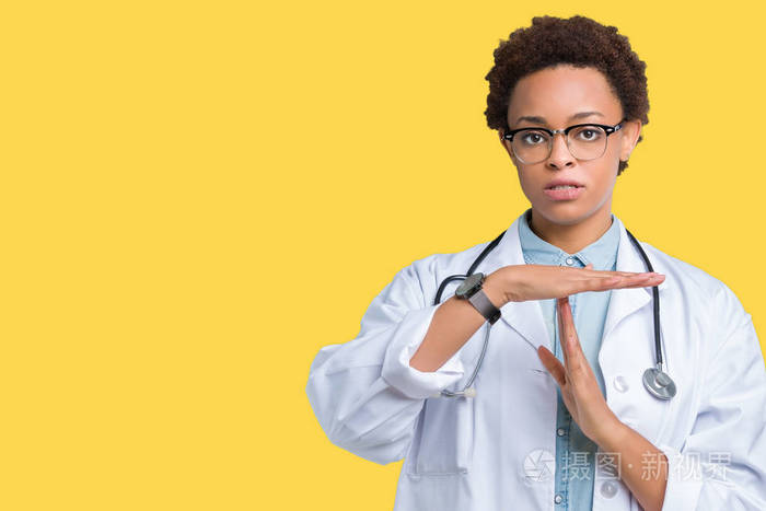 年轻的非裔美国医生女人，穿着医用外套，背景偏僻，做着手势，双手沮丧，脸严肃