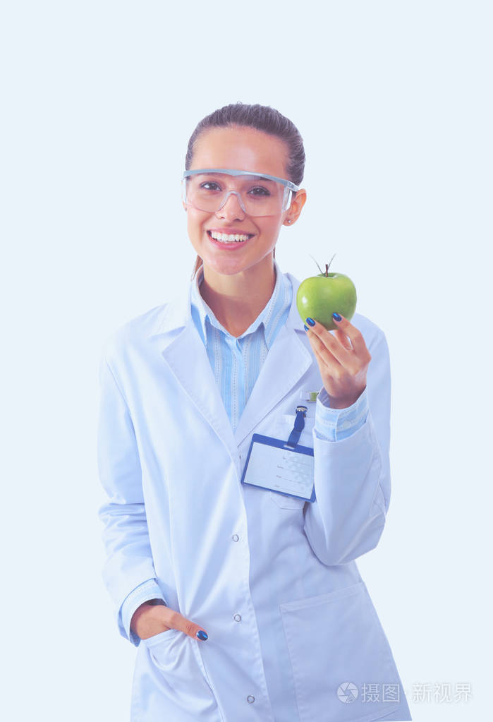 微笑着一个绿色的苹果的女医生.女医生