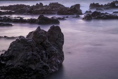 长曝光雾效应海洋背景的岩石自然照片