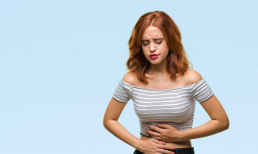 年轻貌美的女人由于消化不良,疼痛感不适而过孤立的背景和手放在肚子