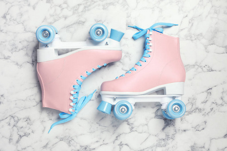 大理石背景上的一对时尚的四轮溜冰鞋