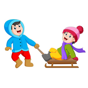 一个穿着蓝色夹克的男孩正在拉冰车，上面有一个女孩。