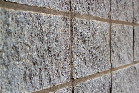 凹凸不平的方石墙. 背景. 抽象的室外壁薄的景深照片