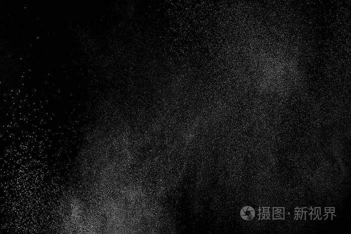 白色粒子在黑色背景上的冻结运动粉末爆炸抽象灰尘覆盖纹理