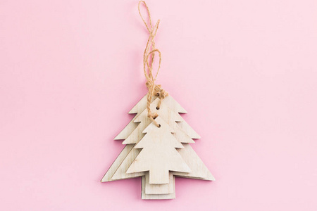 s Day festive decoration, wooden Christmas trees on pink backgro