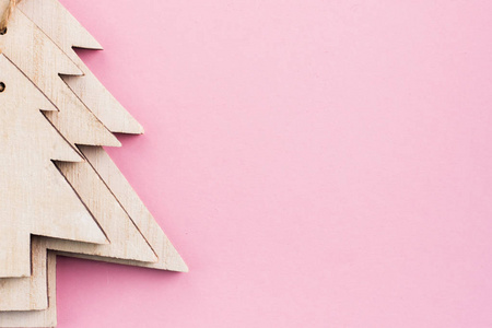 s Day festive decoration, wooden Christmas trees on pink backgro