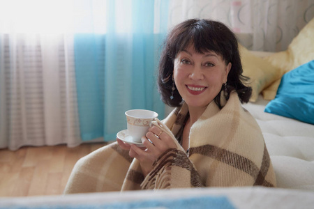无衣客厅里漂亮的中年女人. 一天之内在家的女士照片