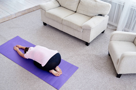 s pose, full length. Relaxing and doing yoga, resting, stretchin