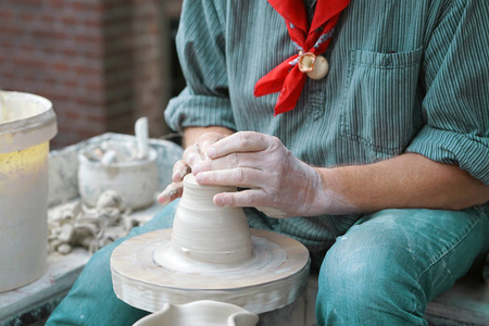 s hands make a clay pitcher, macro. Potter makes a pitcher.