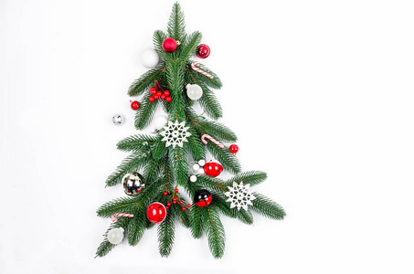 圣诞节背景与红白球和玩具冷杉树枝锥在白色背景。 卡假日概念。 复制顶部视图