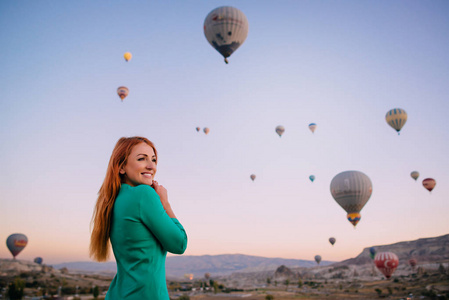 年轻的女游客站在气球的背景