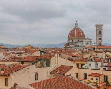 s Bell Tower, under overcast sky, over houses of the historical 