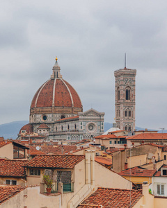 s Bell Tower, under overcast sky, over houses of the historical 