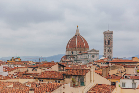 s Bell Tower, under overcast sky, over houses of the historical 