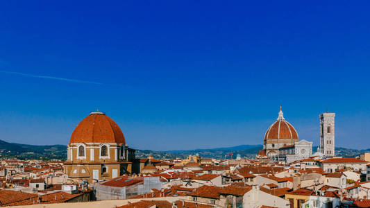 s Bell Tower, and San Lorenzo Basilica under blue sky, over hous