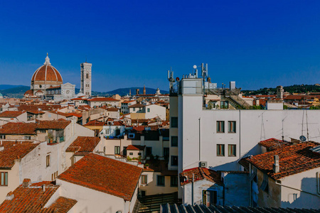 s Bell Tower under blue sky, over houses of the historical cente