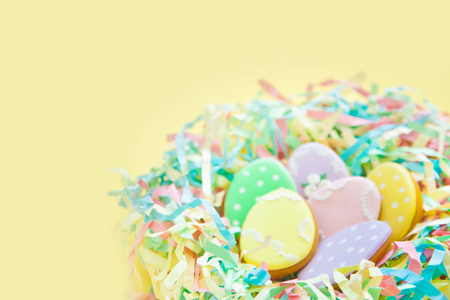 庆祝复活节的糖果。 姜饼形状的复活节兔子和复活节鸡蛋。 白色和彩色背景顶部视图复制空间