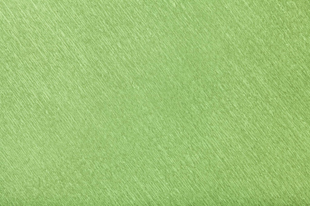 波浪波纹纸特写绿色背景的纹理. 皱纹绉轻橄榄纸板宏观结构.照片